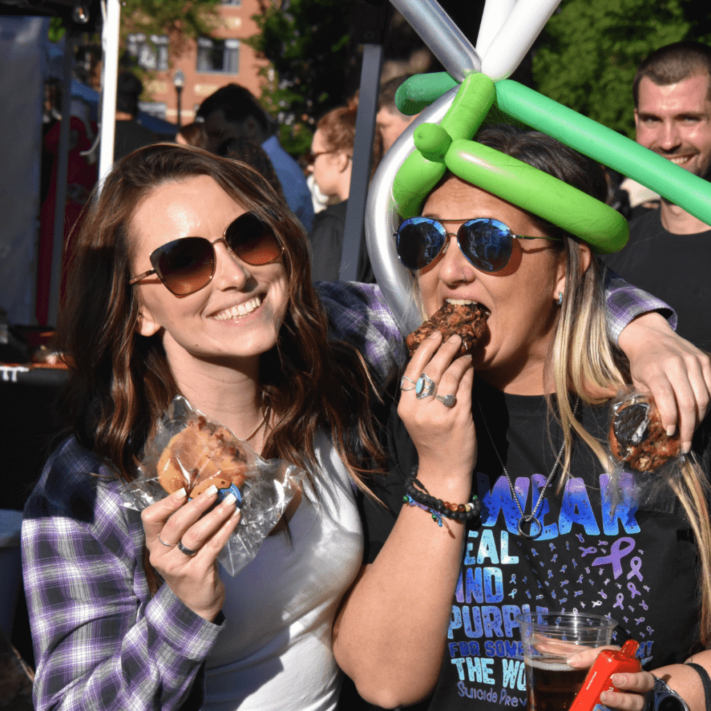 Two For the Love of Dough customers eating a cookie at Taco Fest Market in Columbus Ohio