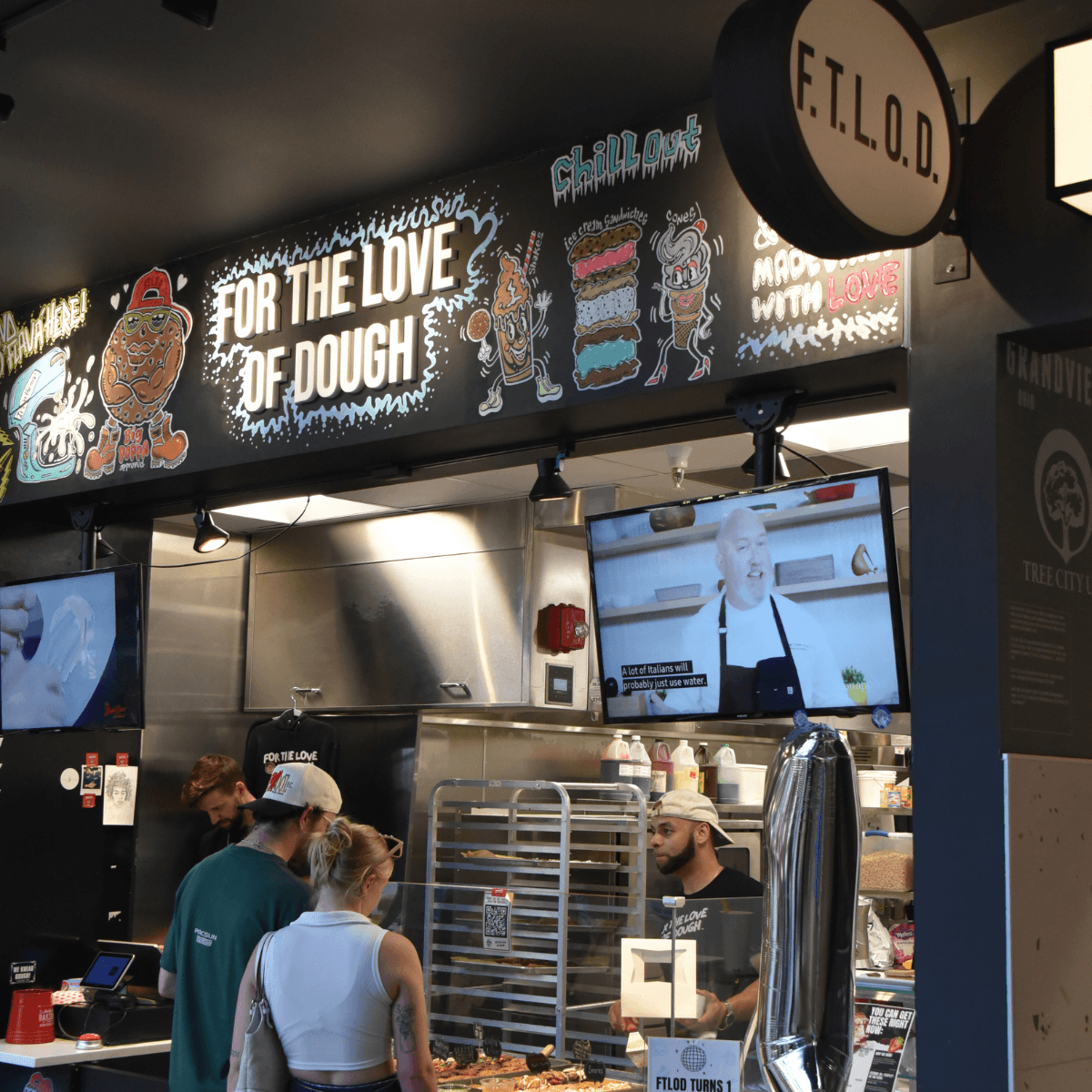 foro the love of dough physical location with two customers being helped