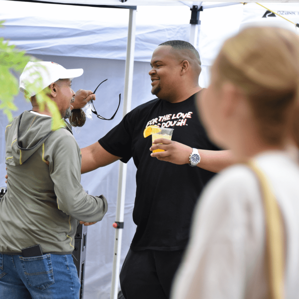 For the Love of Dough team member interacting with customers at a farmers market in Short North, Columbus Ohio