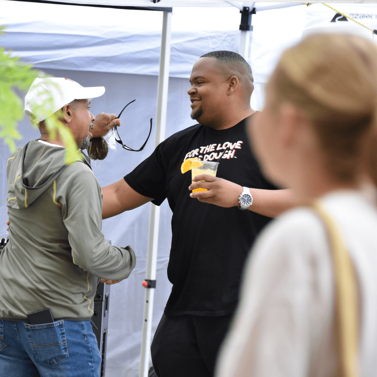For the Love of Dough team member interacting with customers at a farmers market in Short North, Columbus Ohio