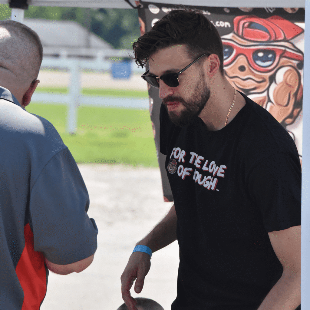For the Love of Dough Co-Owner waiting helping a customer select a cookie at Columbus Food Truck Festival