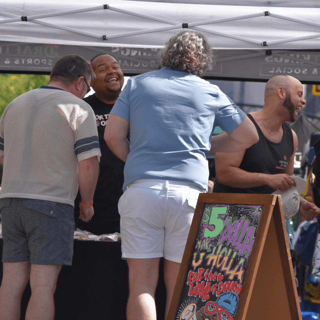For the Love of Dough Co-Owners having a positive interaction with market customers